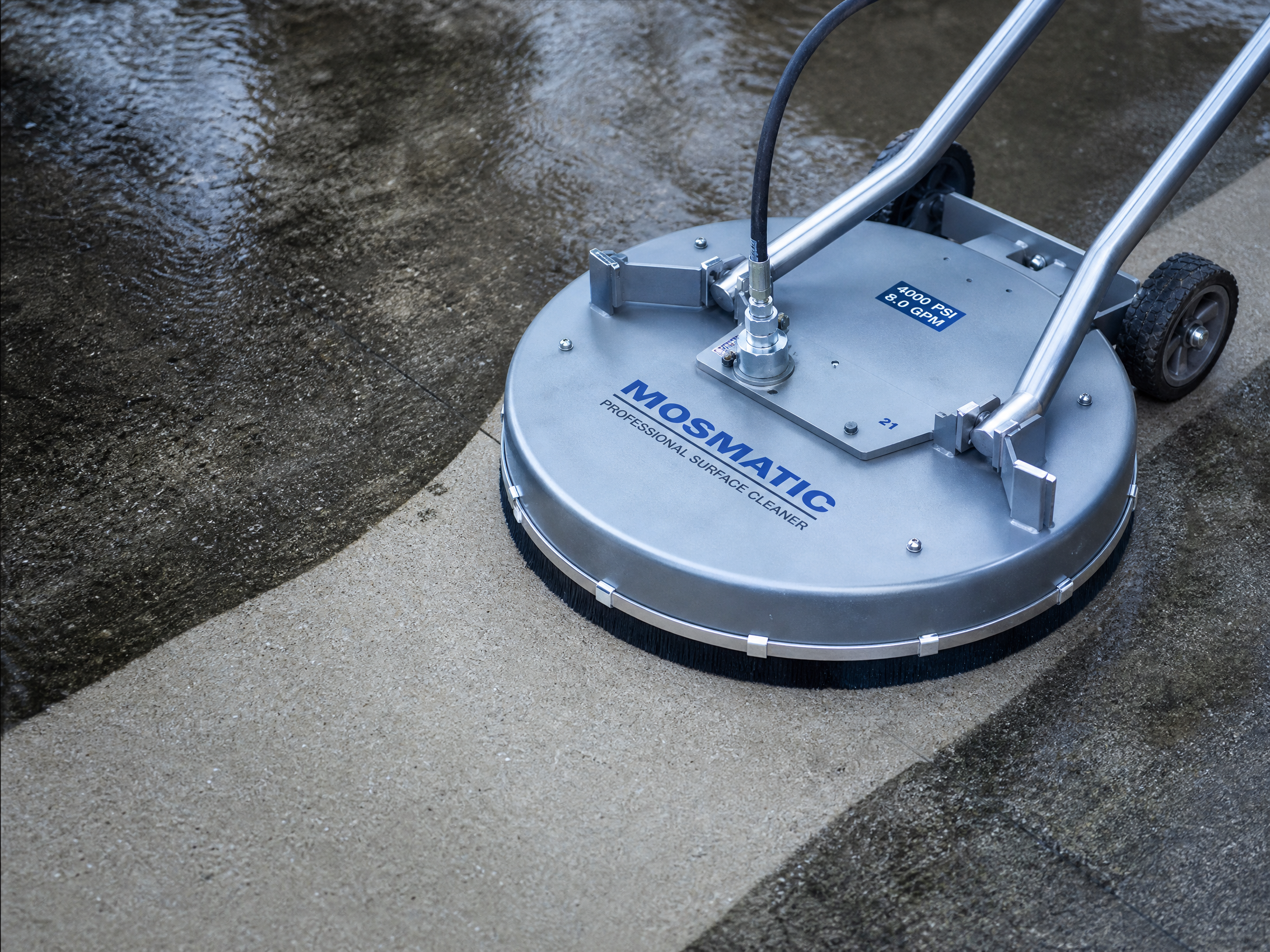 Concrete driveway being cleaned with a pressure washer